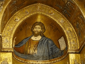 Close-up of the mosaic series in the sanctuary with Christ Pantocrator painted on the dome ceiling of the structure. He is seen in a blue robe and a stroll in hand. 